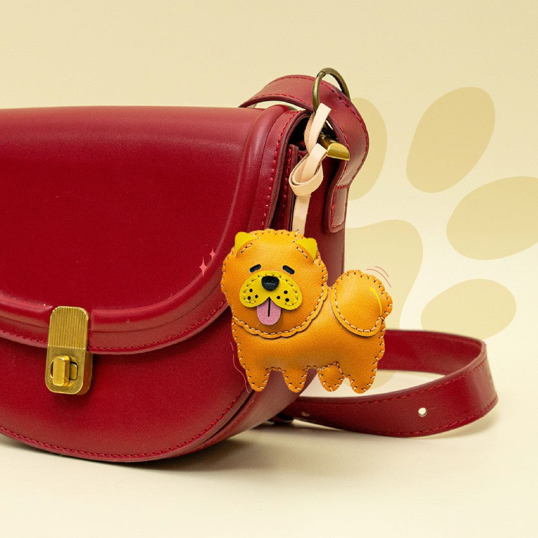 Red handbag with a yellow dog-shaped keychain on a beige background