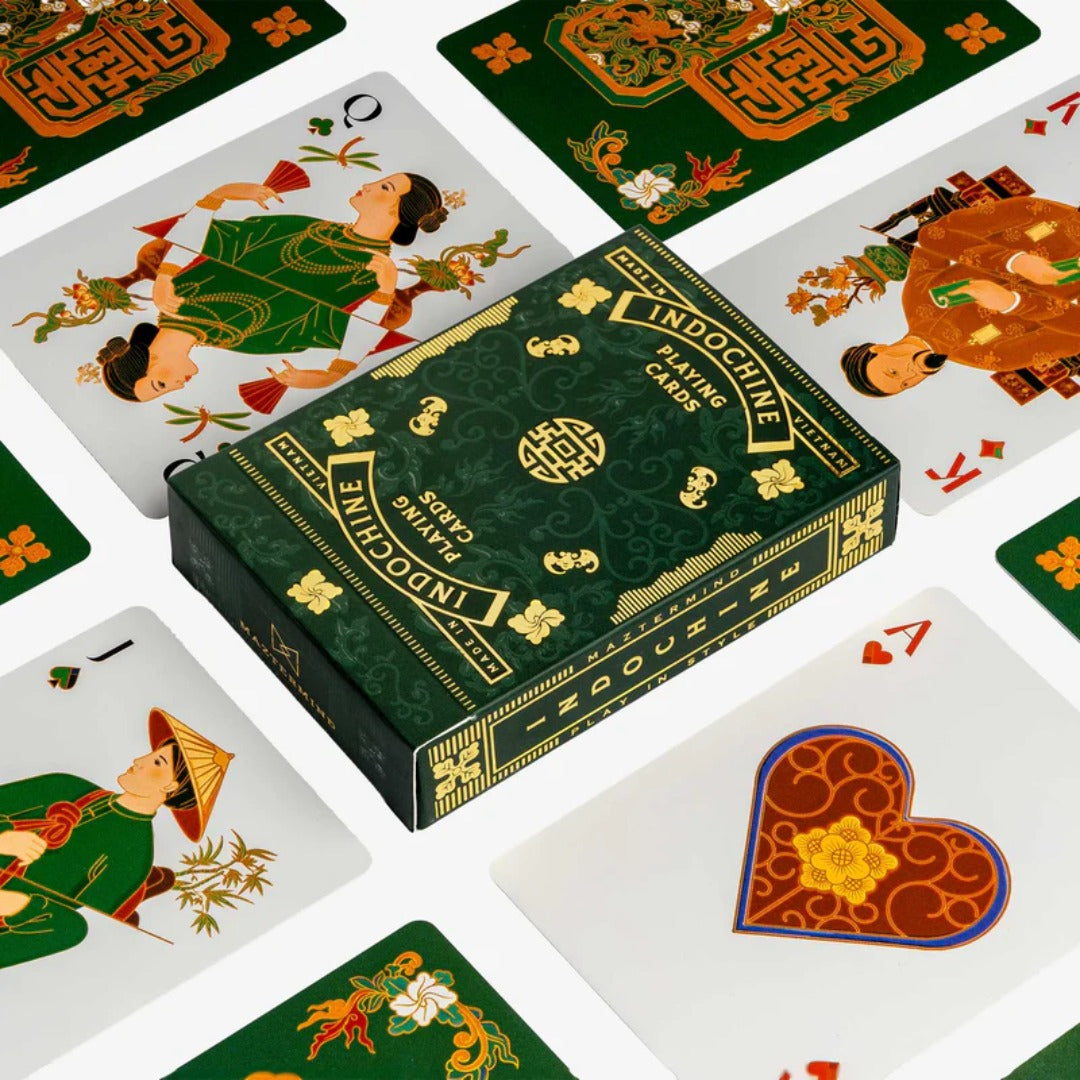 Indochine playing cards with a green box surrounded by cards featuring various illustrations.
